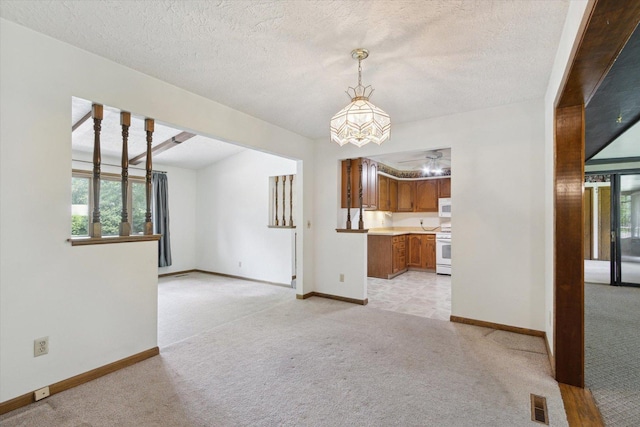 1619 Arnold Ave, Rockford, IL 61108 - unfurnished living room with light carpet, a ceiling fan, and a textured ceiling