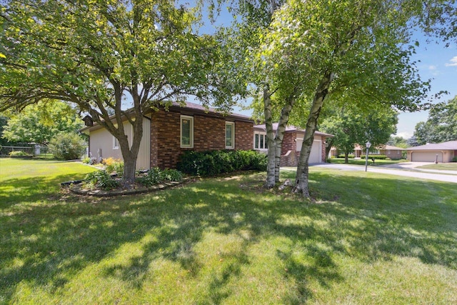 1619 Arnold Ave, Rockford, IL 61108 - ranch-style house with concrete driveway, a front yard, and an attached garage
