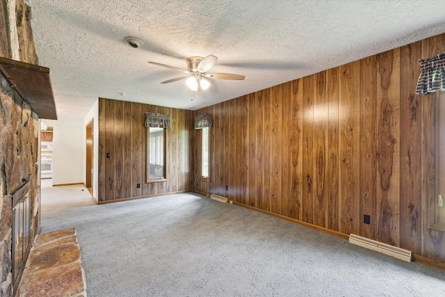 1619 Arnold Ave, Rockford, IL 61108 - carpeted empty room with a ceiling fan, wooden walls, baseboard heating, and a textured ceiling