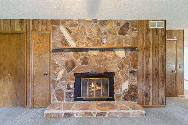 1619 Arnold Ave, Rockford, IL 61108 - detailed view of carpet floors, a stone fireplace, a textured ceiling, and wood walls
