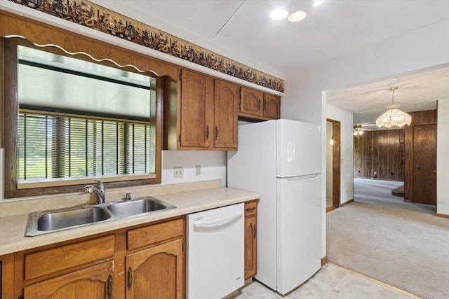 1619 Arnold Ave, Rockford, IL 61108 - kitchen featuring white appliances, brown cabinets, light countertops, hanging light fixtures, and light carpet