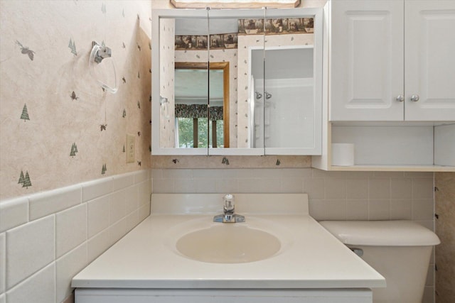 1619 Arnold Ave, Rockford, IL 61108 - bathroom with tile walls, vanity, and wallpapered walls