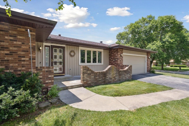 1619 Arnold Ave, Rockford, IL 61108 - single story home with driveway, an attached garage, brick siding, board and batten siding, and a front yard