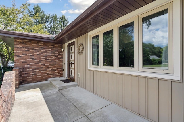 1619 Arnold Ave, Rockford, IL 61108 - property entrance with board and batten siding, a patio area, and brick siding