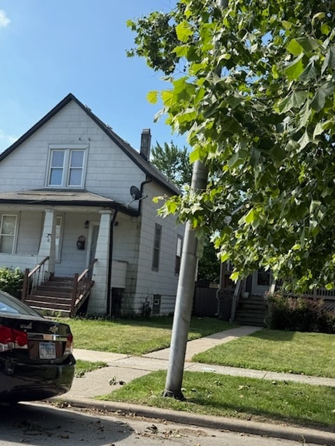 24 E 137th St, Riverdale, IL 60827 - bungalow-style home with a front lawn, a porch, and a chimney