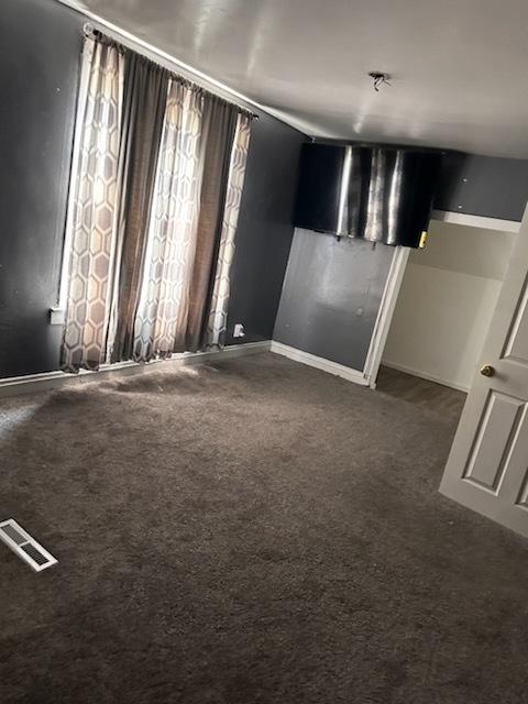 24 E 137th St, Riverdale, IL 60827 - unfurnished room featuring dark colored carpet