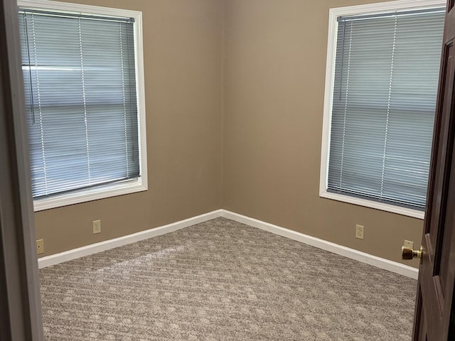541 W Grove St, Bloomington, IL 61701 - carpeted empty room featuring baseboards