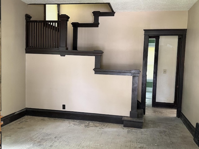 541 W Grove St, Bloomington, IL 61701 - spare room with concrete floors and a textured ceiling