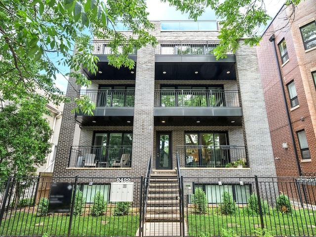2422 W Lyndale St Unit 1E, Chicago, IL 60647 - view of property with a fenced front yard