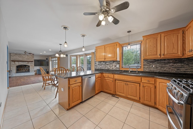 19600 Brookridge Dr, Tinley Park, IL 60487 - kitchen with appliances with stainless steel finishes, dark countertops, a peninsula, light tile patterned flooring, and a ceiling fan
