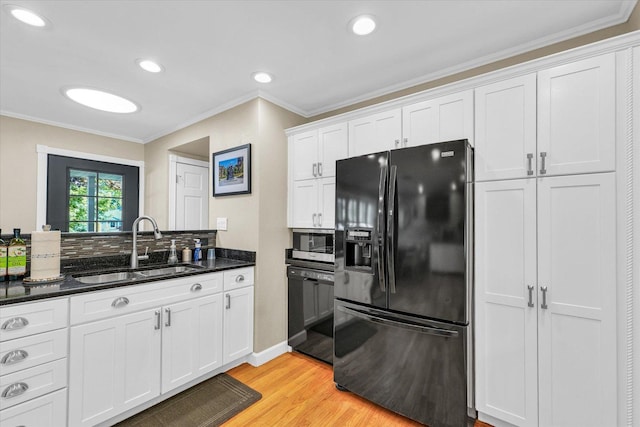 411 Hessel Blvd, Champaign, IL 61820 - kitchen featuring black appliances, light wood-style floors, white cabinetry, crown molding, and dark stone countertops