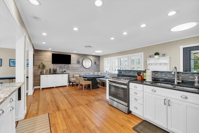 411 Hessel Blvd, Champaign, IL 61820 - kitchen featuring gas range, tasteful backsplash, white cabinetry, dark stone countertops, and recessed lighting