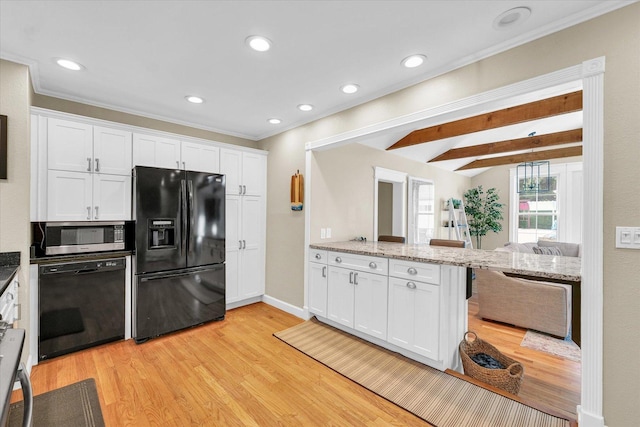 411 Hessel Blvd, Champaign, IL 61820 - kitchen with black appliances, a peninsula, white cabinets, light wood-style floors, and light stone counters
