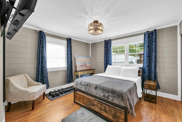 411 Hessel Blvd, Champaign, IL 61820 - bedroom featuring wood finished floors, wood walls, and a chandelier