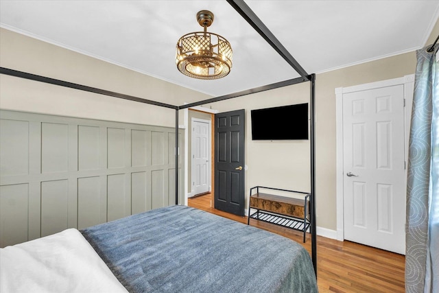 411 Hessel Blvd, Champaign, IL 61820 - bedroom with wood finished floors, crown molding, a chandelier, and a closet