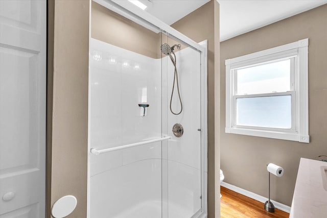 411 Hessel Blvd, Champaign, IL 61820 - bathroom featuring a stall shower, wood finished floors, and vanity