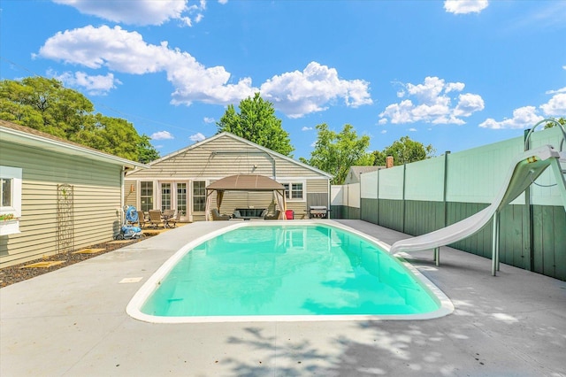 411 Hessel Blvd, Champaign, IL 61820 - view of swimming pool featuring a gazebo, a water slide, a patio, and a fenced backyard