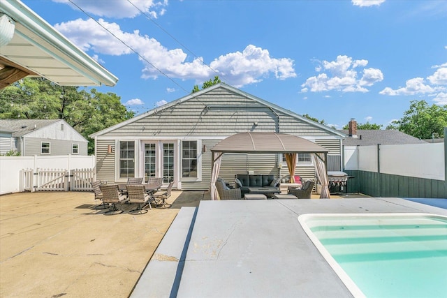 411 Hessel Blvd, Champaign, IL 61820 - rear view of house featuring a gazebo, a gate, an outdoor hangout area, and a patio area