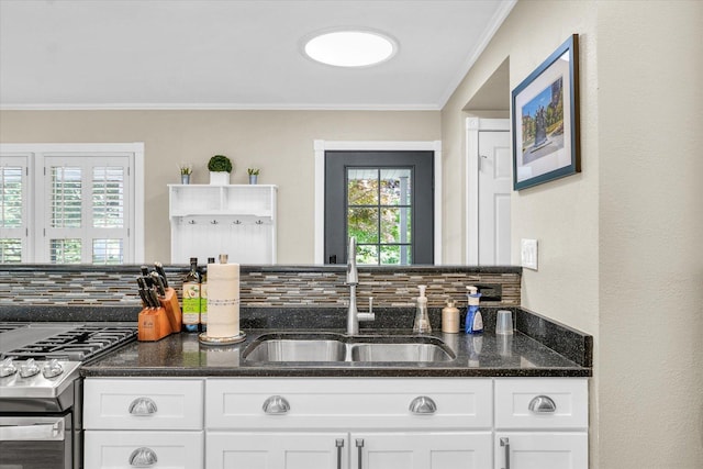 411 Hessel Blvd, Champaign, IL 61820 - kitchen with stainless steel gas range oven, tasteful backsplash, white cabinets, healthy amount of natural light, and crown molding