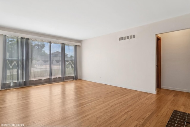 8024 W Charmaine Rd, Norridge, IL 60706 - empty room featuring wood finished floors and baseboards