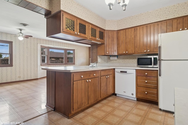 8024 W Charmaine Rd, Norridge, IL 60706 - kitchen with white appliances, wallpapered walls, brown cabinets, a peninsula, and light countertops