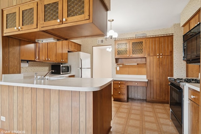 8024 W Charmaine Rd, Norridge, IL 60706 - kitchen featuring black appliances, wallpapered walls, a peninsula, light floors, and brown cabinetry