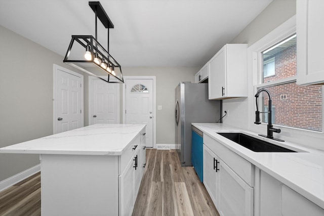 10823 S Ewing Ave, Chicago, IL 60617 - kitchen with light wood-type flooring, a center island, and white cabinets