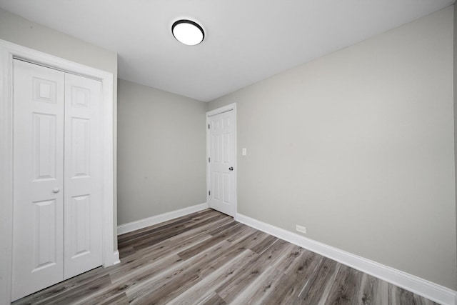 10823 S Ewing Ave, Chicago, IL 60617 - unfurnished bedroom featuring wood finished floors and a closet