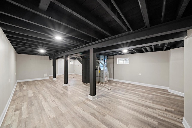 10823 S Ewing Ave, Chicago, IL 60617 - below grade area featuring wood finished floors and heating unit