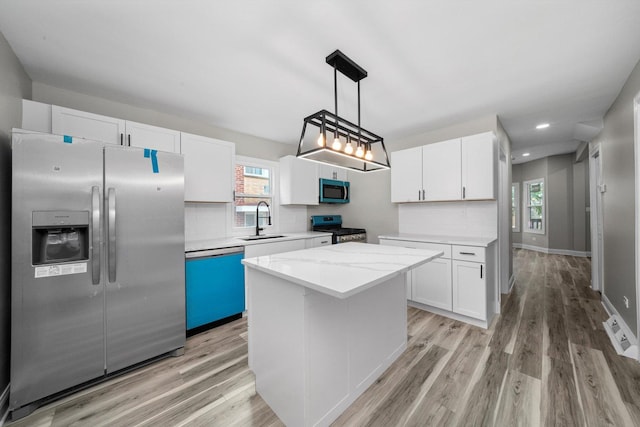 10823 S Ewing Ave, Chicago, IL 60617 - kitchen with stainless steel appliances, light wood-style flooring, white cabinets, tasteful backsplash, and recessed lighting