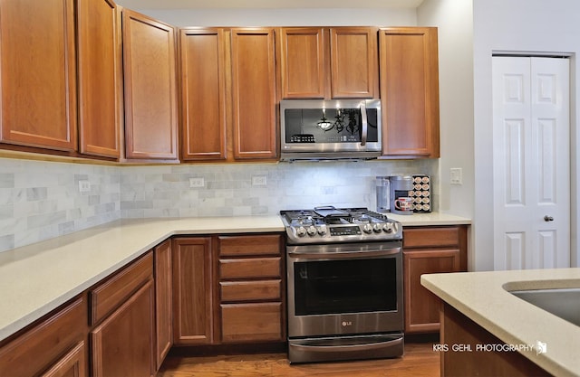 1114 Barkston Ln, Aurora, IL 60502 - kitchen featuring appliances with stainless steel finishes, tasteful backsplash, and light countertops