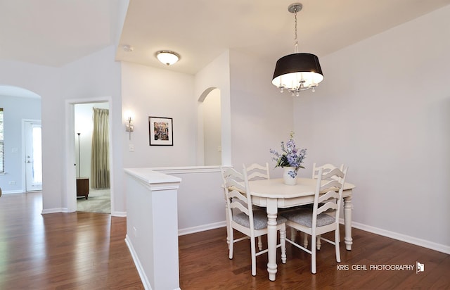 1114 Barkston Ln, Aurora, IL 60502 - dining area featuring arched walkways, dark wood-style floors, and a chandelier