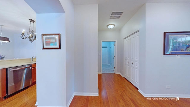 1114 Barkston Ln, Aurora, IL 60502 - corridor with light wood-style flooring and a chandelier