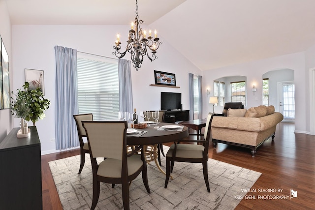 1114 Barkston Ln, Aurora, IL 60502 - dining area with arched walkways, a chandelier, dark wood-style flooring, and high vaulted ceiling