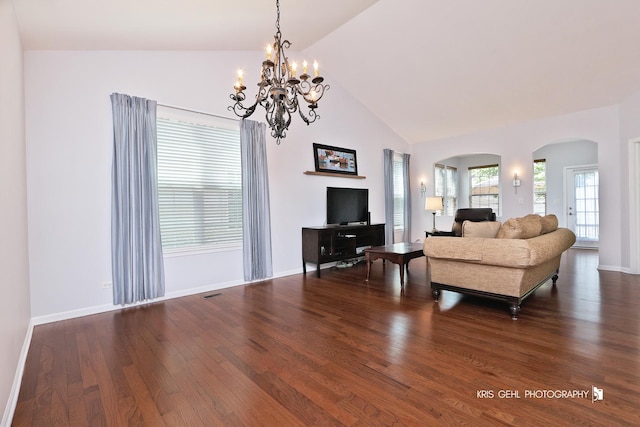 1114 Barkston Ln, Aurora, IL 60502 - living room with arched walkways, dark wood finished floors, vaulted ceiling, and a chandelier