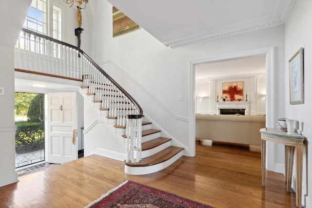 424 Sheridan Rd, Kenilworth, IL 60043 - entryway with wood finished floors, stairs, a fireplace, and a high ceiling