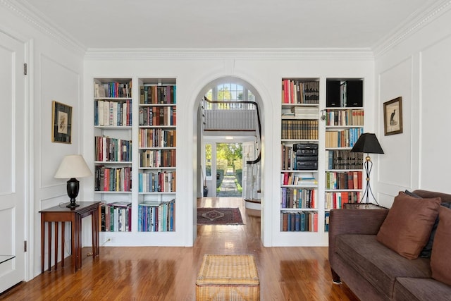 424 Sheridan Rd, Kenilworth, IL 60043 - living area featuring built in shelves, wood finished floors, crown molding, and arched walkways