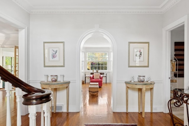 424 Sheridan Rd, Kenilworth, IL 60043 - hall with ornamental molding, wood finished floors, arched walkways, and a decorative wall