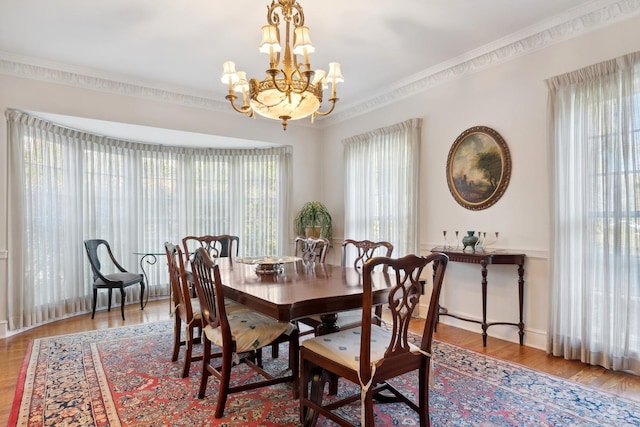 424 Sheridan Rd, Kenilworth, IL 60043 - dining space featuring a chandelier, wood finished floors, and crown molding
