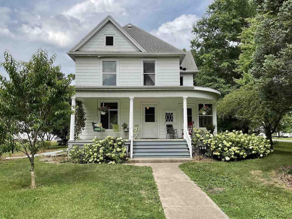 108 N Walnut St, Lindenwood, IL 61049 - view of front of property featuring a porch, a front yard, and a shingled roof