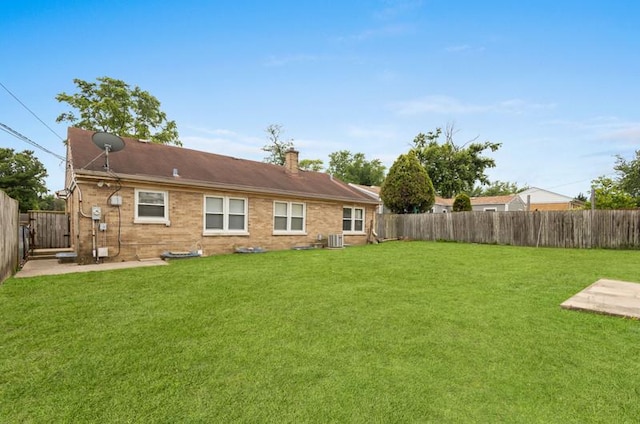 251 W 10th St, Chicago Heights, IL 60411 - back of property featuring a fenced backyard and a chimney
