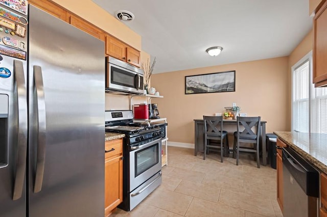 251 W 10th St, Chicago Heights, IL 60411 - kitchen featuring appliances with stainless steel finishes, light stone countertops, light tile patterned flooring, and a desk