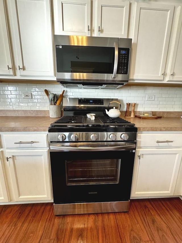 1321 Acorn Dr, Crest Hill, IL 60403 - kitchen with appliances with stainless steel finishes, white cabinets, and dark wood finished floors