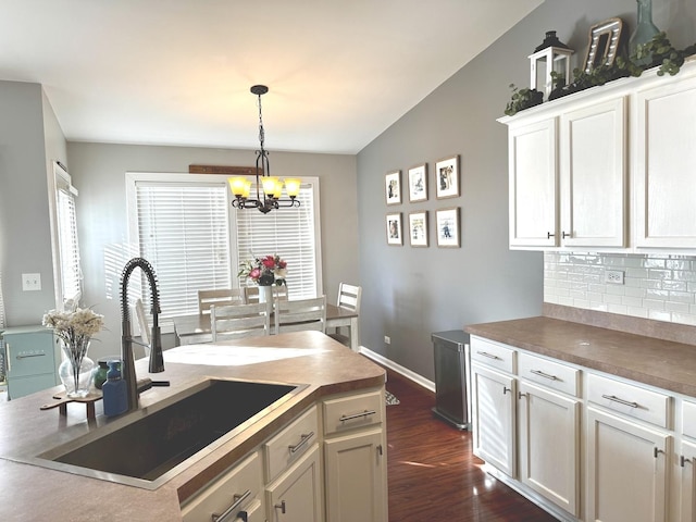 1321 Acorn Dr, Crest Hill, IL 60403 - kitchen featuring a chandelier, dark wood finished floors, backsplash, decorative light fixtures, and an island with sink