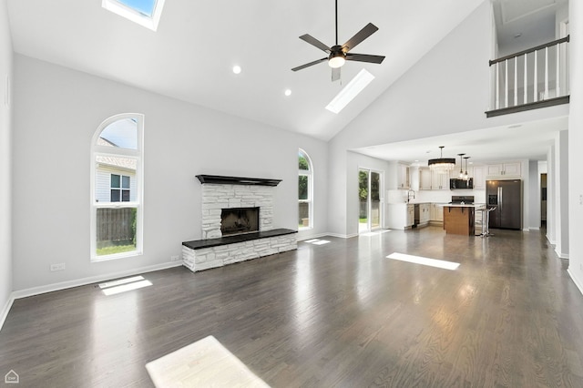 13636 Savanna Dr, Plainfield, IL 60544 - unfurnished living room with high vaulted ceiling, a skylight, plenty of natural light, a fireplace, and ceiling fan