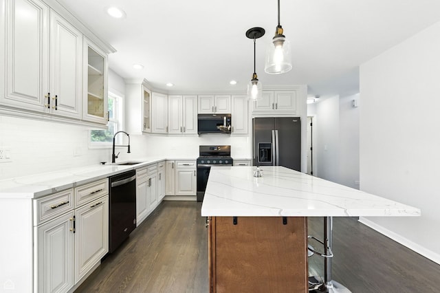 13636 Savanna Dr, Plainfield, IL 60544 - kitchen featuring appliances with stainless steel finishes, dark wood-style flooring, white cabinets, light stone countertops, and tasteful backsplash