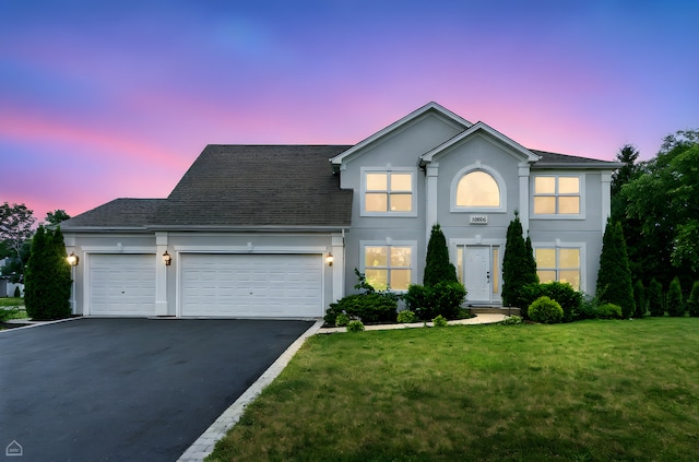 13636 Savanna Dr, Plainfield, IL 60544 - traditional home with asphalt driveway, an attached garage, a front yard, stucco siding, and a shingled roof