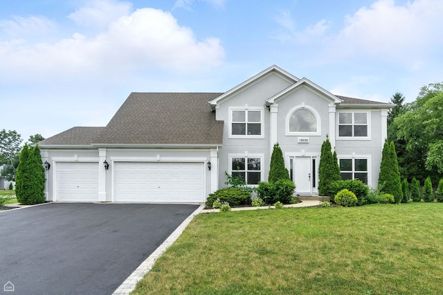 13636 Savanna Dr, Plainfield, IL 60544 - colonial house with a garage, driveway, a front yard, and stucco siding