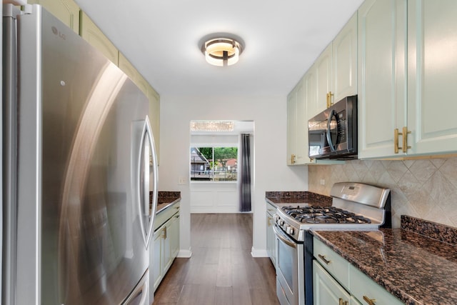 496 Navajo Trl S Unit 496, Wheeling, IL 60090 - kitchen with appliances with stainless steel finishes, backsplash, dark wood-type flooring, and dark stone countertops