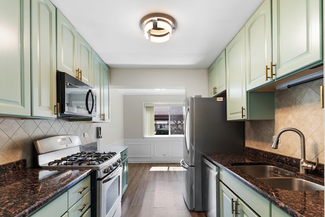 496 Navajo Trl S Unit 496, Wheeling, IL 60090 - kitchen with green cabinets, appliances with stainless steel finishes, decorative backsplash, and dark stone countertops